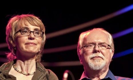 Former Rep. Gabrielle Giffords (D-Ariz.) holds hands with ex-aide Ron Barber, who is running to serve out the remainder of his retired boss&amp;#039; term.