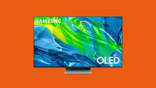 A Samsung S95B TV face-on, on an orange background. 