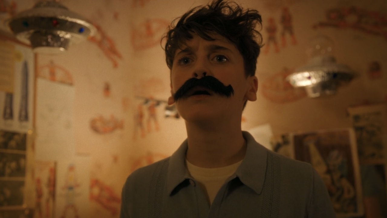 Phil wearing fake mustache in Teddy's room in IT: Welcome to Derry