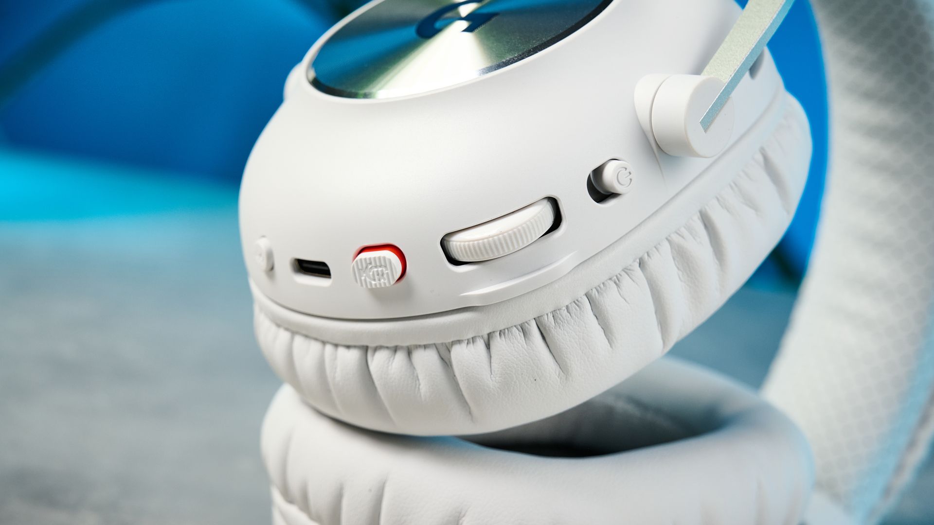 The Logitech G Pro X3 Lightspeed headset in white, on a stone surface.