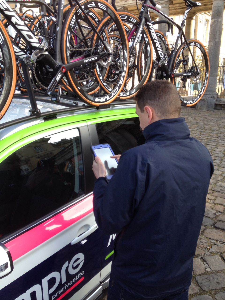 The UCI official with the blue tablet