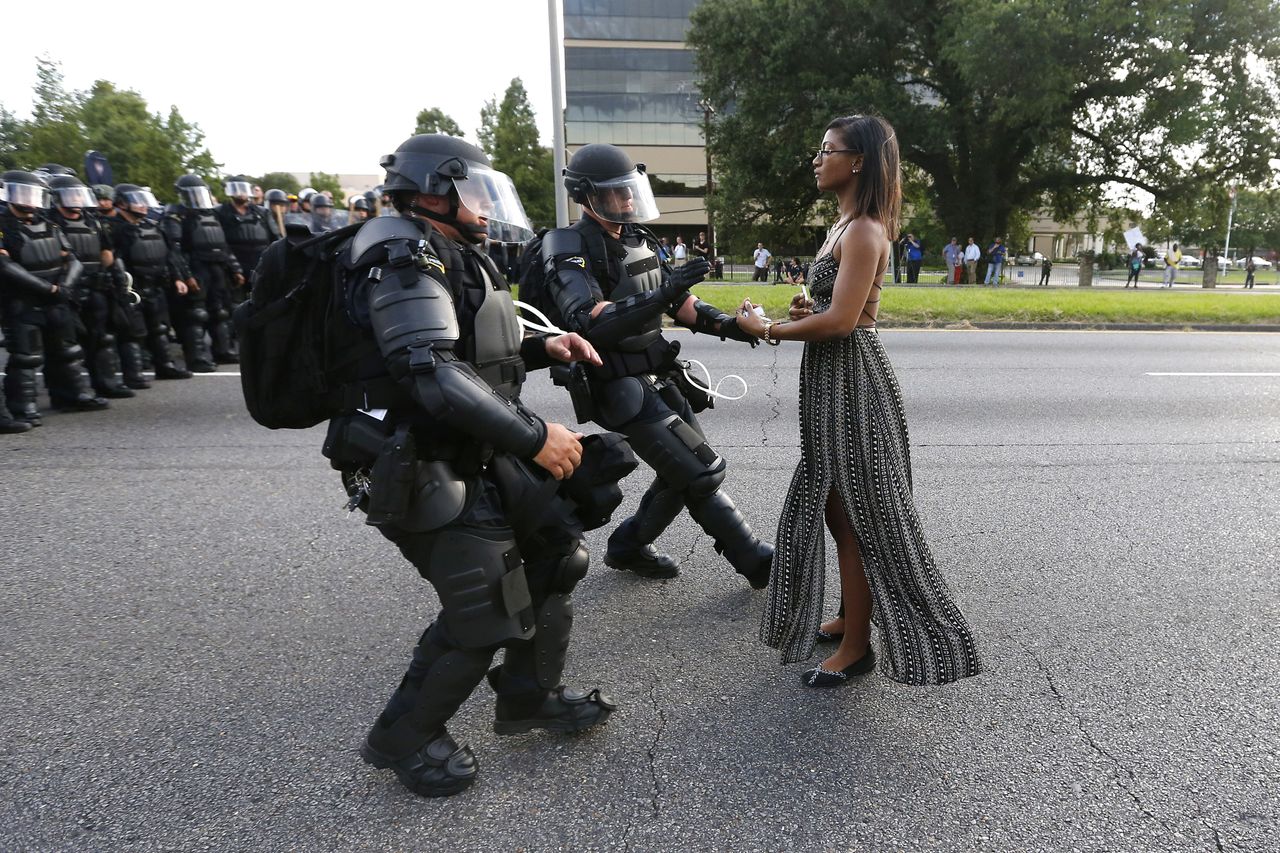 A demonstrator protesting the shooting death of Alton Sterling is detained by law enforcement near the headquarters of the Baton Rouge Police Department in Baton Rouge, Louisiana on July 9, 2