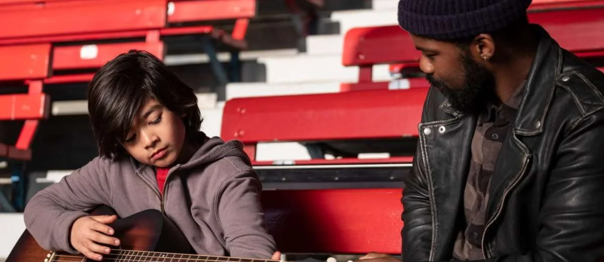 Joe and Larry practice guitar at Yankee stadium.