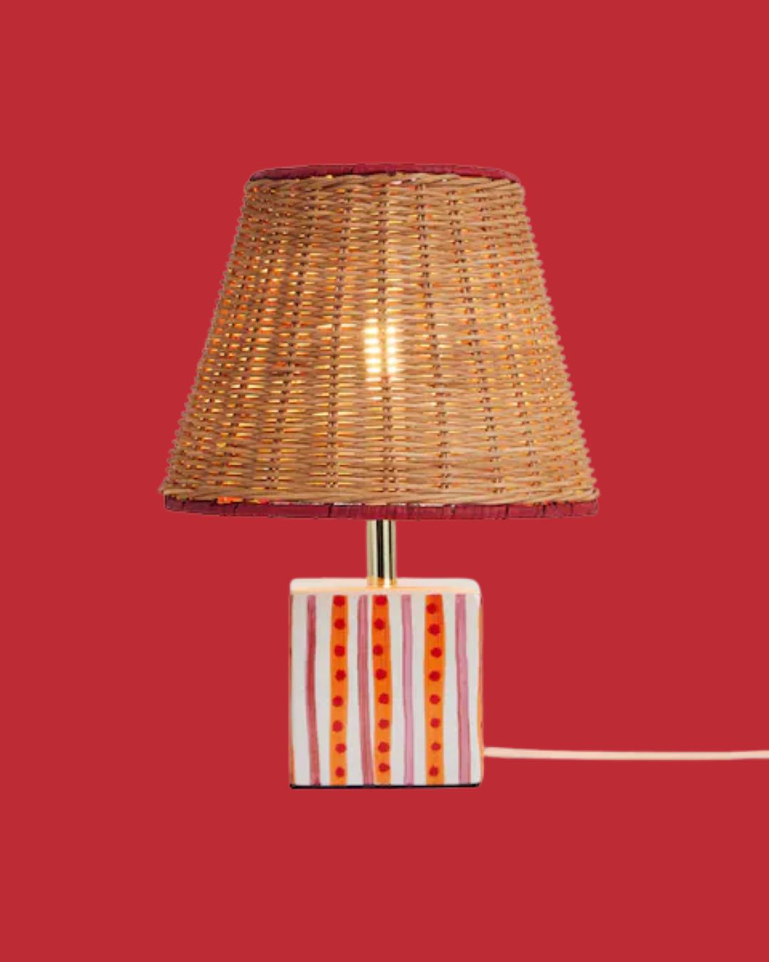 Orange/Pink Ceramic Table Lamp against red background.
