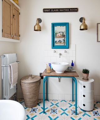 bathroom makeover with upcycled vanity unit and matching blue floor