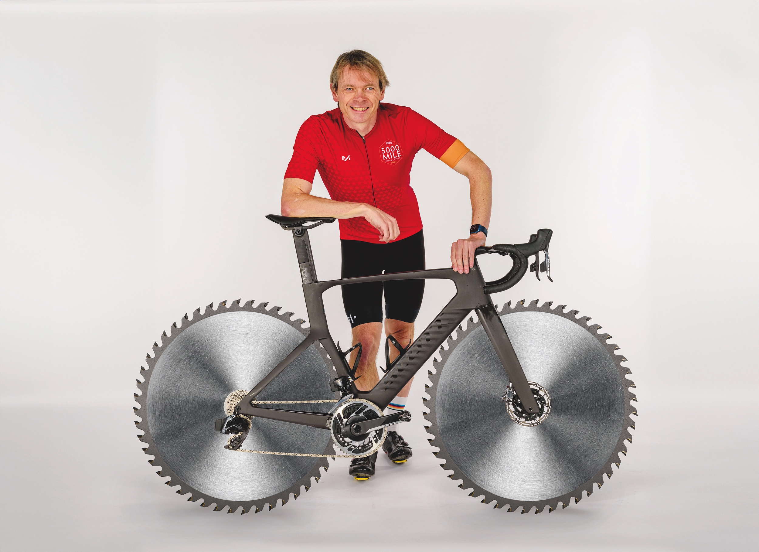Dr Hutch poses with an imaginary bike that has circular saw blades for wheels