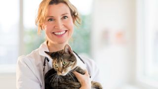 Woman vet holding cat