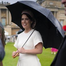 Princess Eugenie wears a white wrap dress at a garden party appearance in London