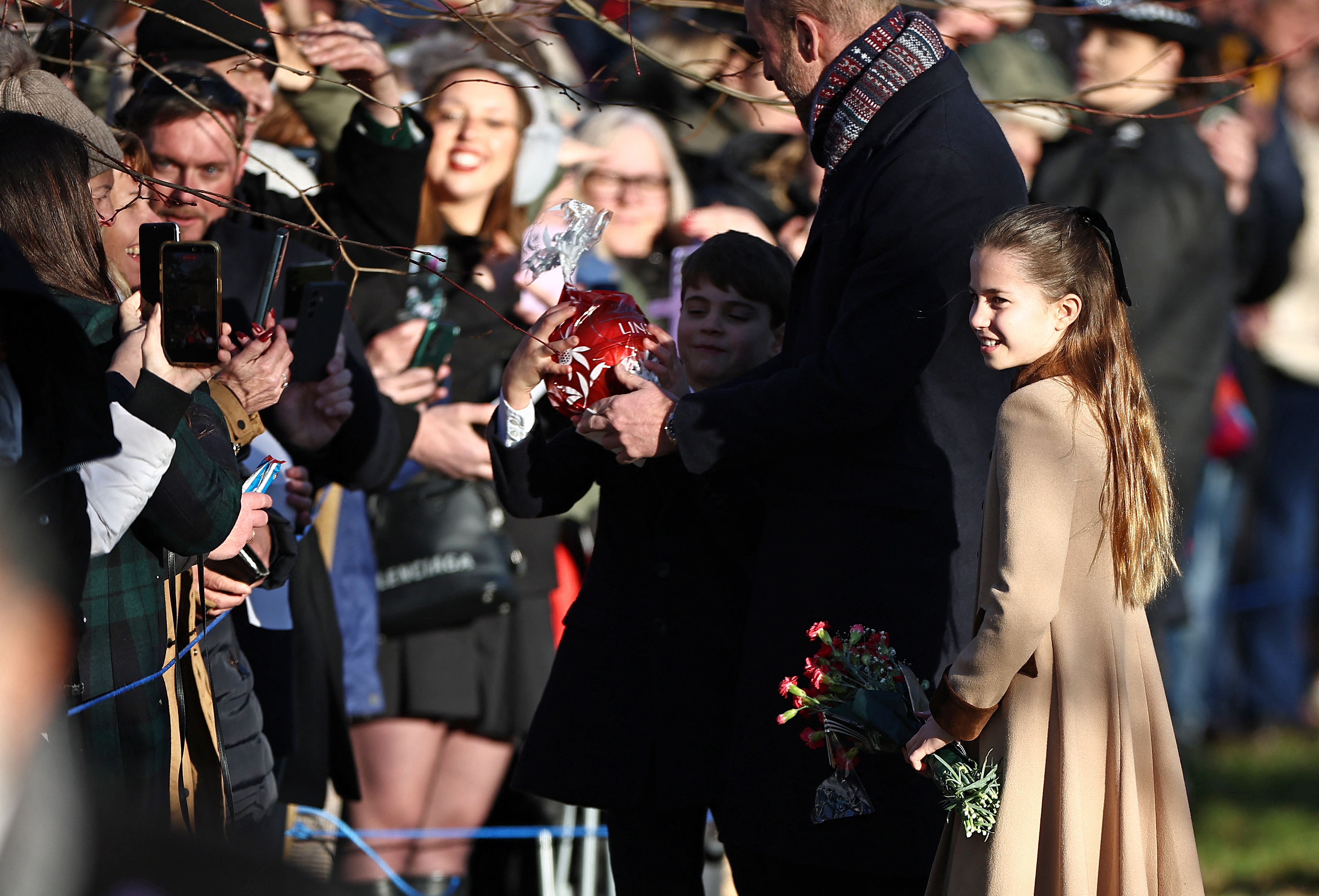 Prince Louis grabs a giant chocolate gift from a fan and his dad runs damage control