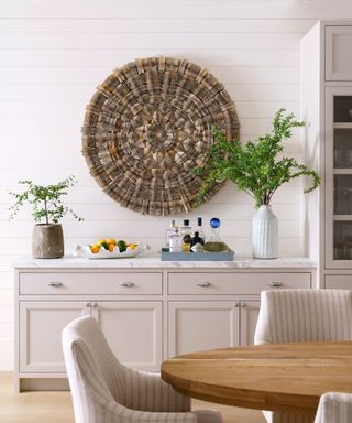 dining room with wooden table and round wall art