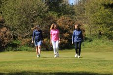 Three women golfers on fairway