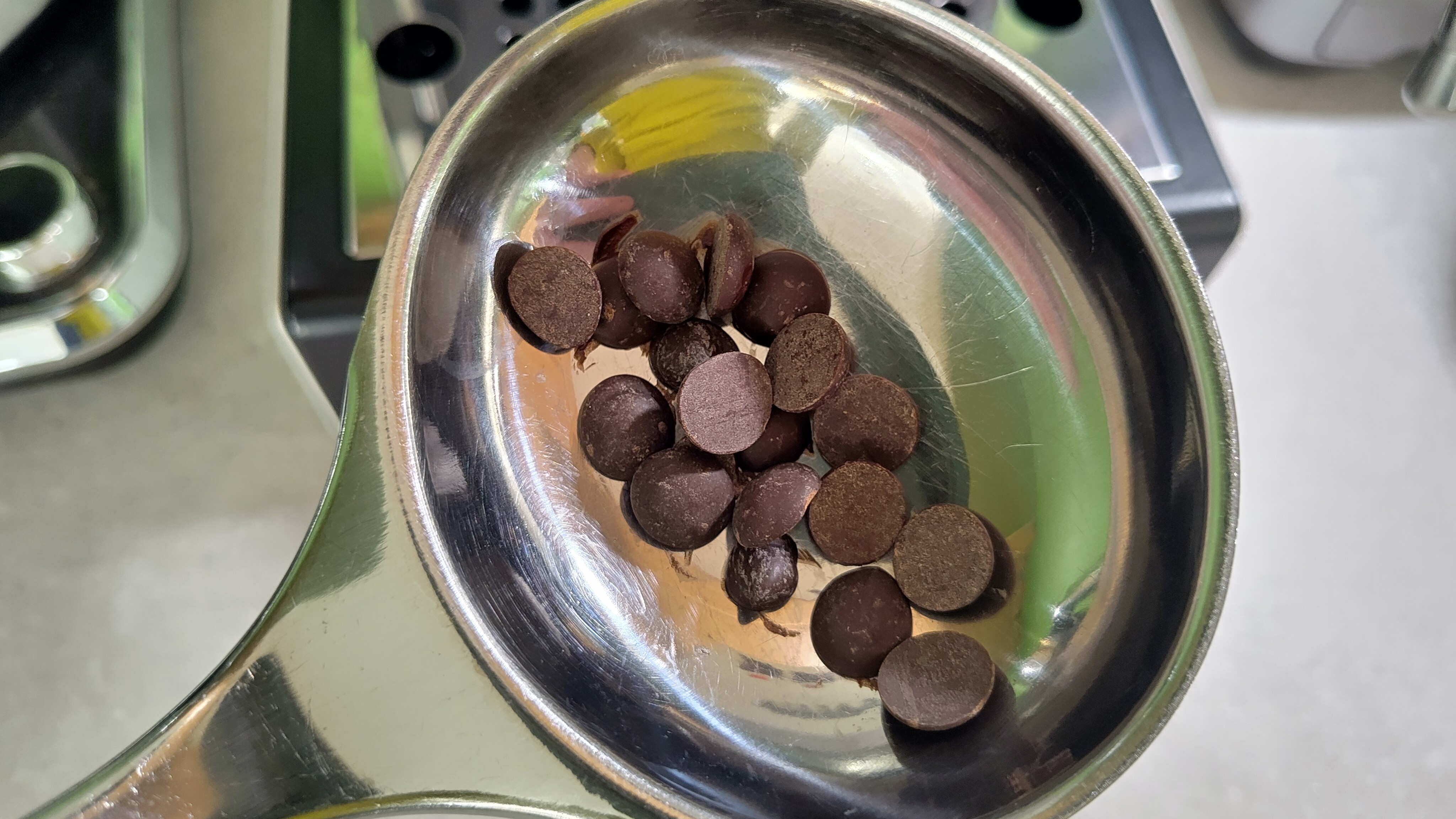 Chocolate chips in metal ladle