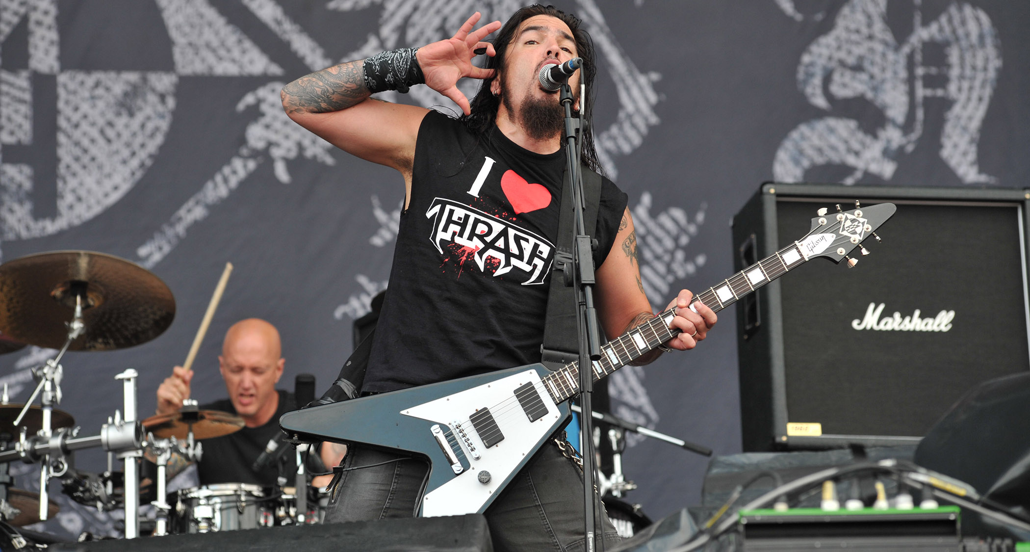 Robb Flynn asks the crowd for more during Machine Head&#039;s 2009 Sonisphere performance. He wears an &amp;quot;I love thrash&amp;quot; T-shirt and plays a custom V-style