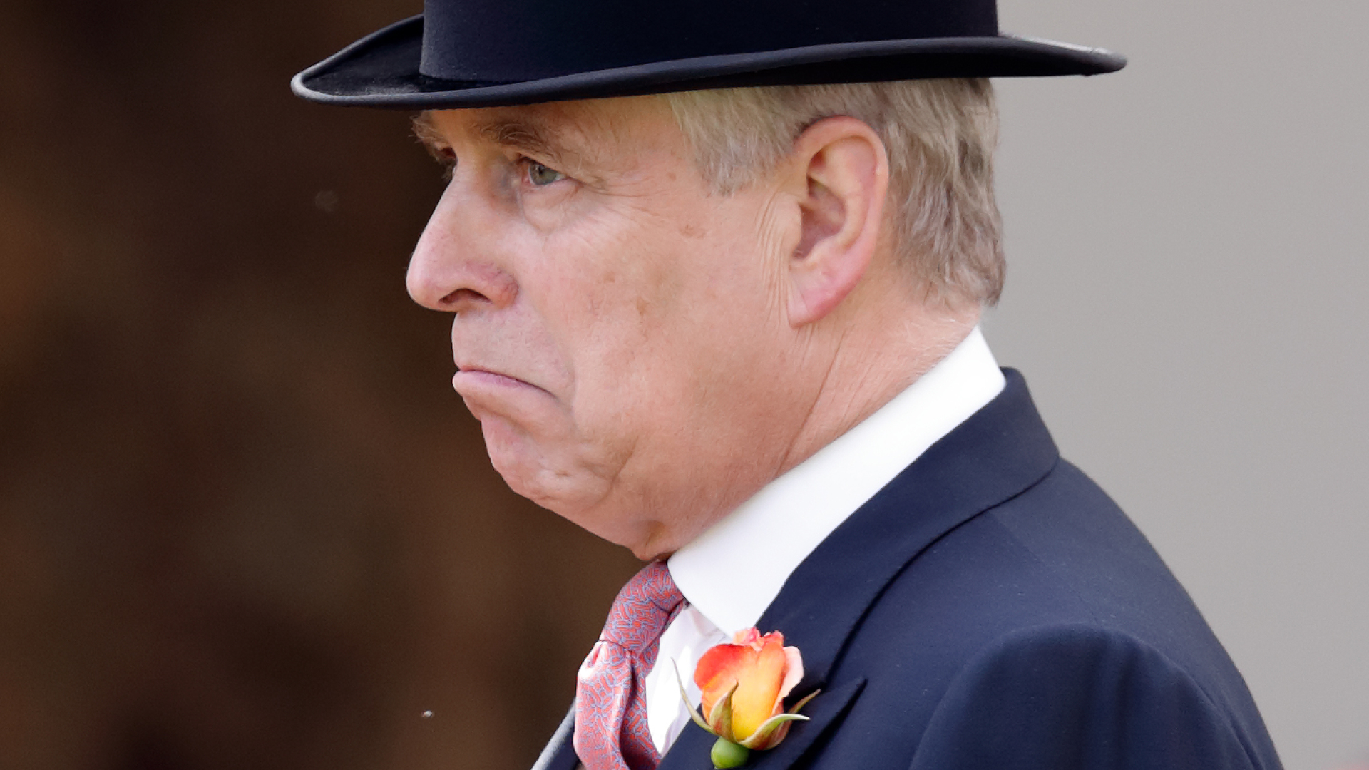 Ex-Prince Andrew is wearing a top hat and has a flower in his lapel as he makes a sad crying face