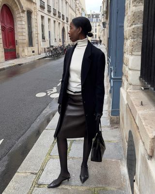 Fashion influencer @sylviemus_ wearing a rich-looking outfit styled with elegant winter staples for 2025.