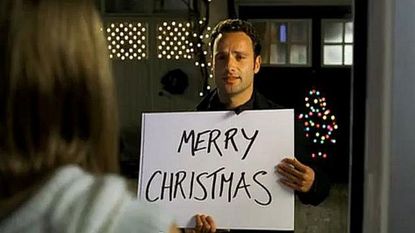 Mark (Andrew Lincoln) from Love Actually holding up Merry Christmas sign