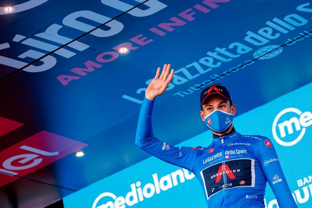 Team Ineos rider Italys Filippo Ganna wearing a face mask celebrates on the podium after receiving the azzurra jersey in the 8th stage of the Giro dItalia 2020 cycling race a 200kilometer route between Giovinazzo and Vieste on October 10 2020 Photo by Luca Bettini AFP Photo by LUCA BETTINIAFP via Getty Images