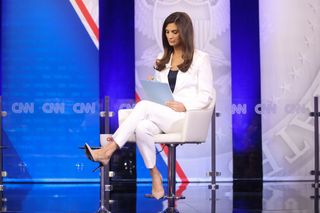 Kaitlan Collins in in a white Michael Kors suit moderating the 2023 CNN Republican Presidential Town Hall.