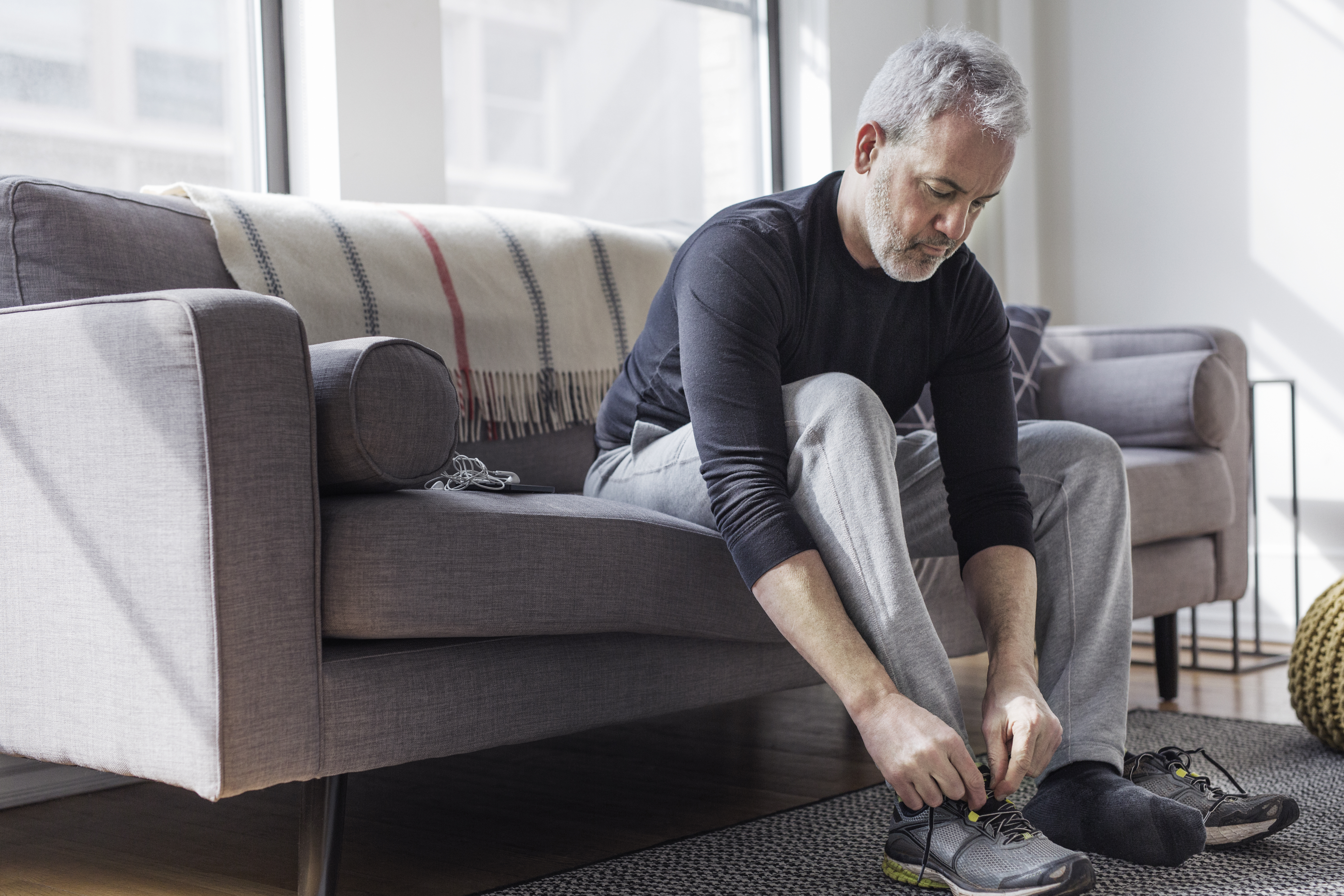 Man putting on running shoes