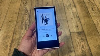 Activo P1 hi-res music player held in hand with Fleetwood Mac Rumours on player