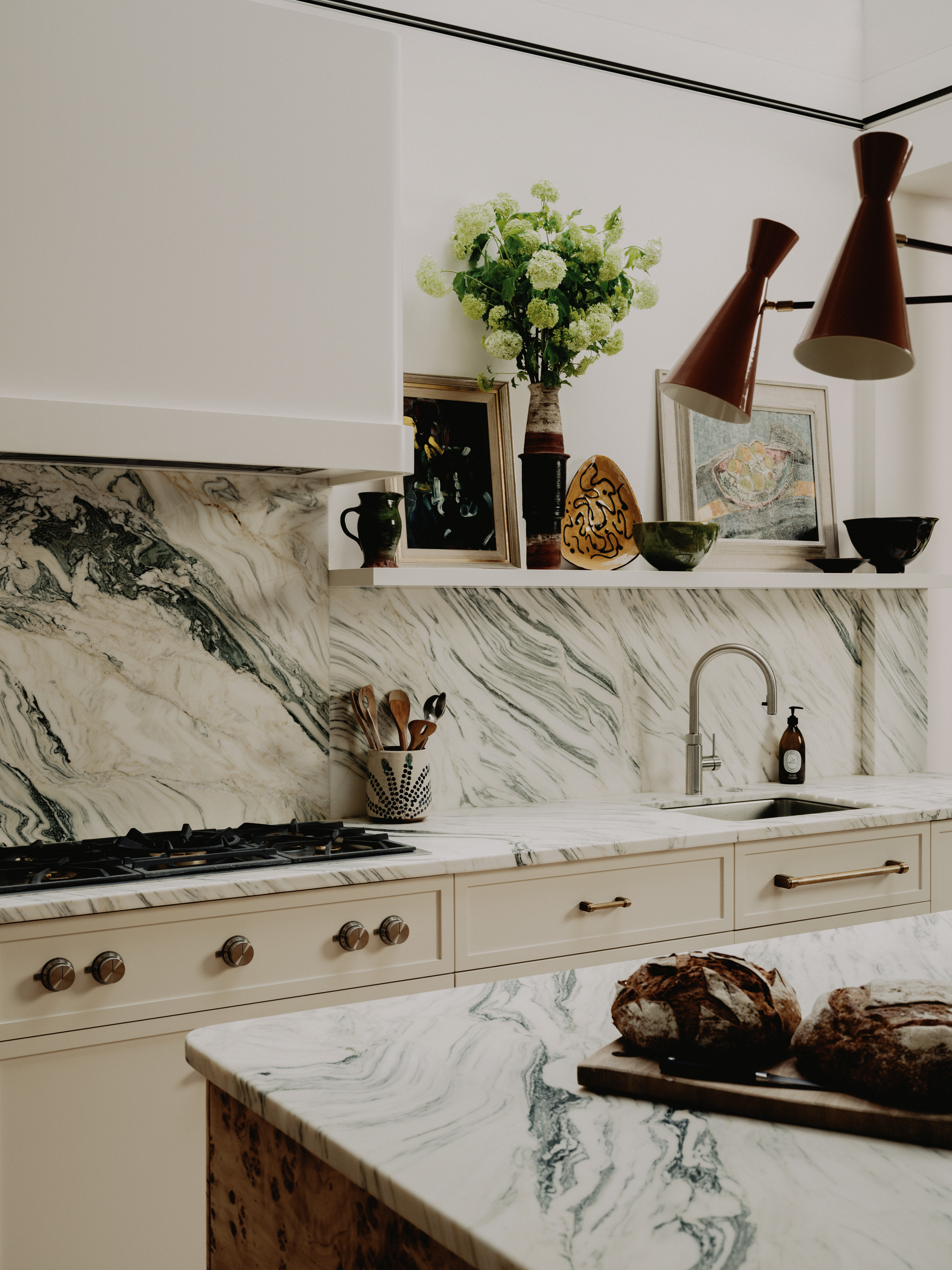 In this kitchen by Studio Vero, swirling Arabescato Verde marble adds a dynamic edge