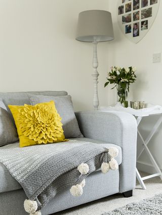 living room with grey sofa and white wall