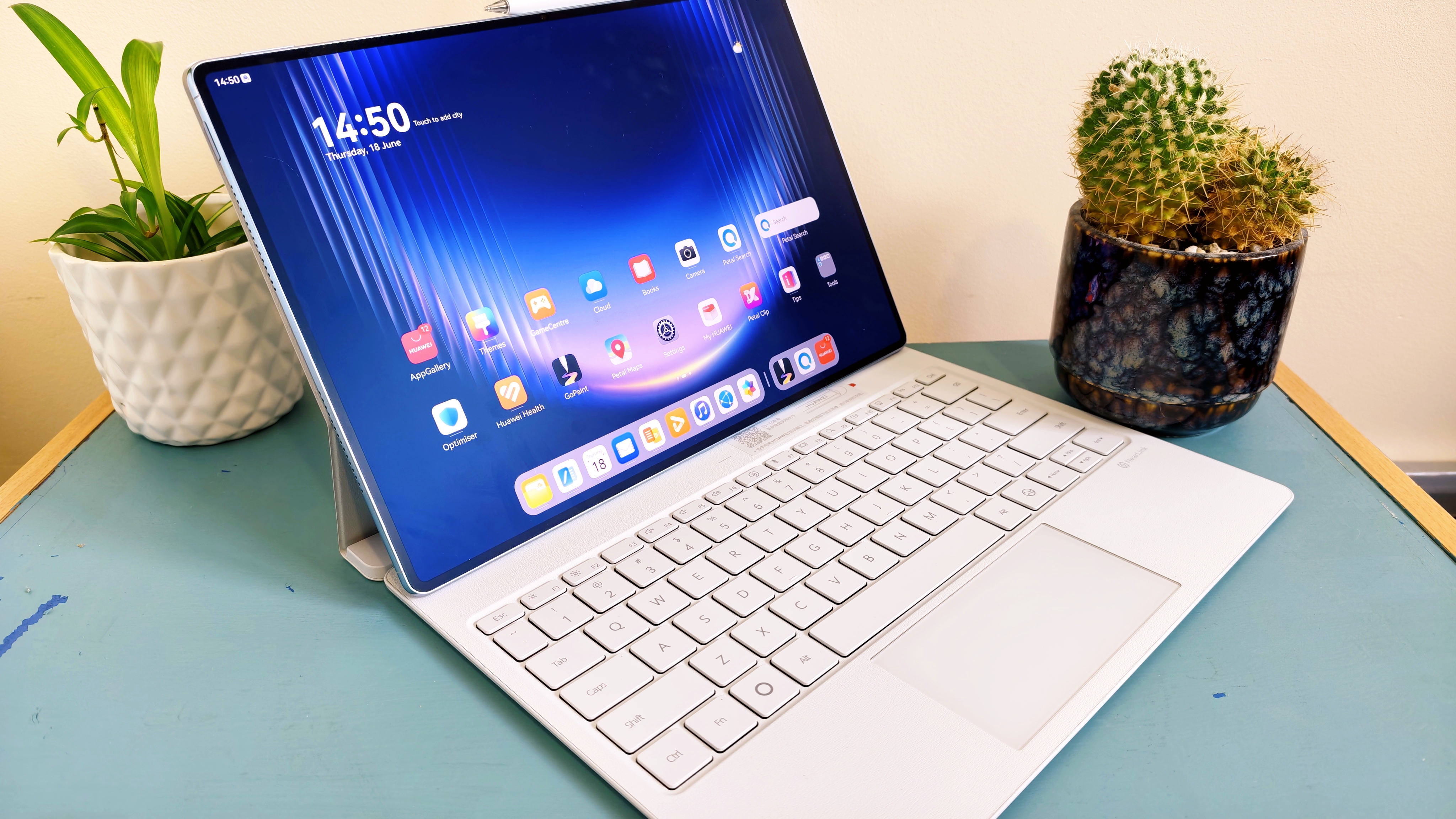 A Huawei MatePad Pro Max tablet on a blue-green table
