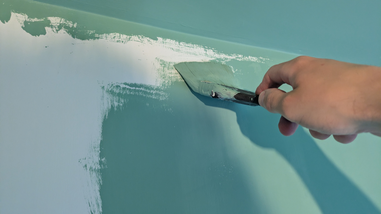 Painting a wall using a paintbrush