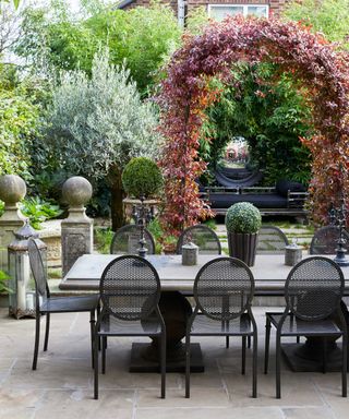modern outdoor dining area with archway and mirror