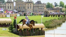 Emily King jumps Valmy Biats into water in front of the house at Badminton Horse Trials