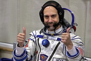 US space tourist Richard Garriott gestures after putting on a space suit at the Baikonur cosmodrome, in Kazakhstan, on October 12, 2008. US space tourist Richard Garriott is set to blast off for the International Space Station (ISS) aboard a Soyuz TMA-13 rocket from the Baikonur cosmodrome with Michael Fink of the US and Russia's Iouri Lonchakov on October 12. AFP PHOTO / DMITRY KOSTYUKOV