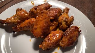 Chicken wings made for The Super Bowl on a white plate