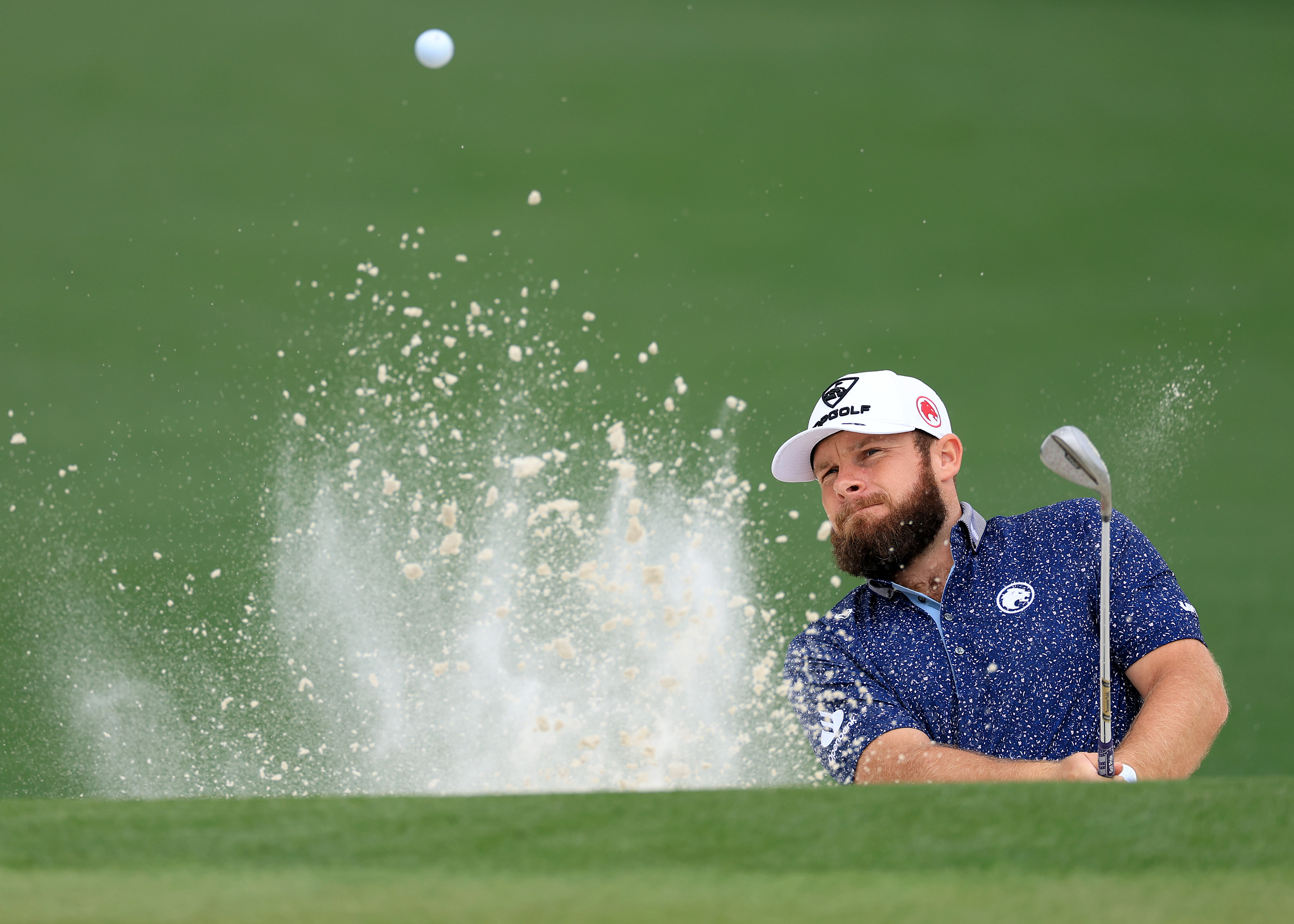 Tyrrell Hatton plays a bunker shot at The Masters