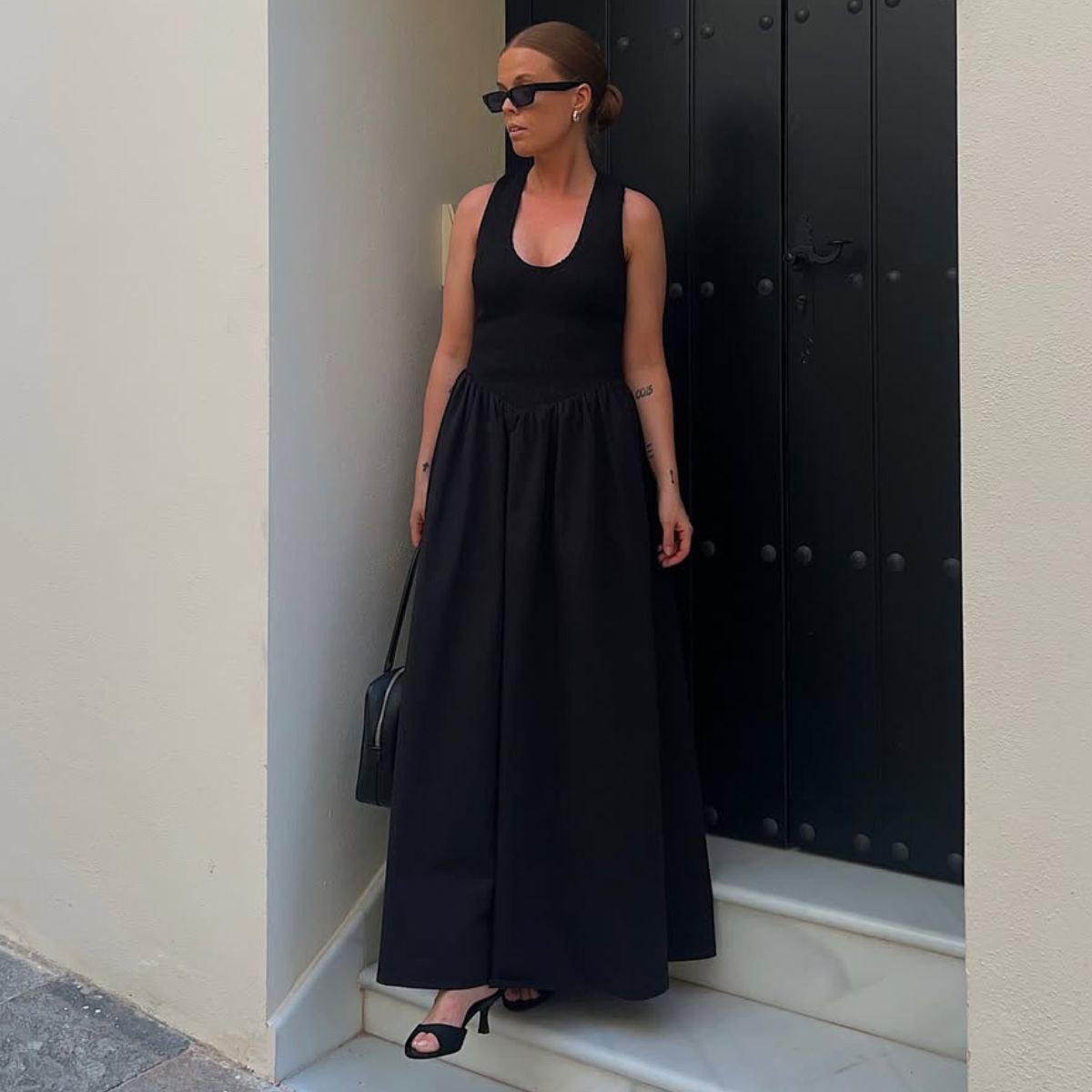 @haaannajohansson wears a black drop-waist dress with heels