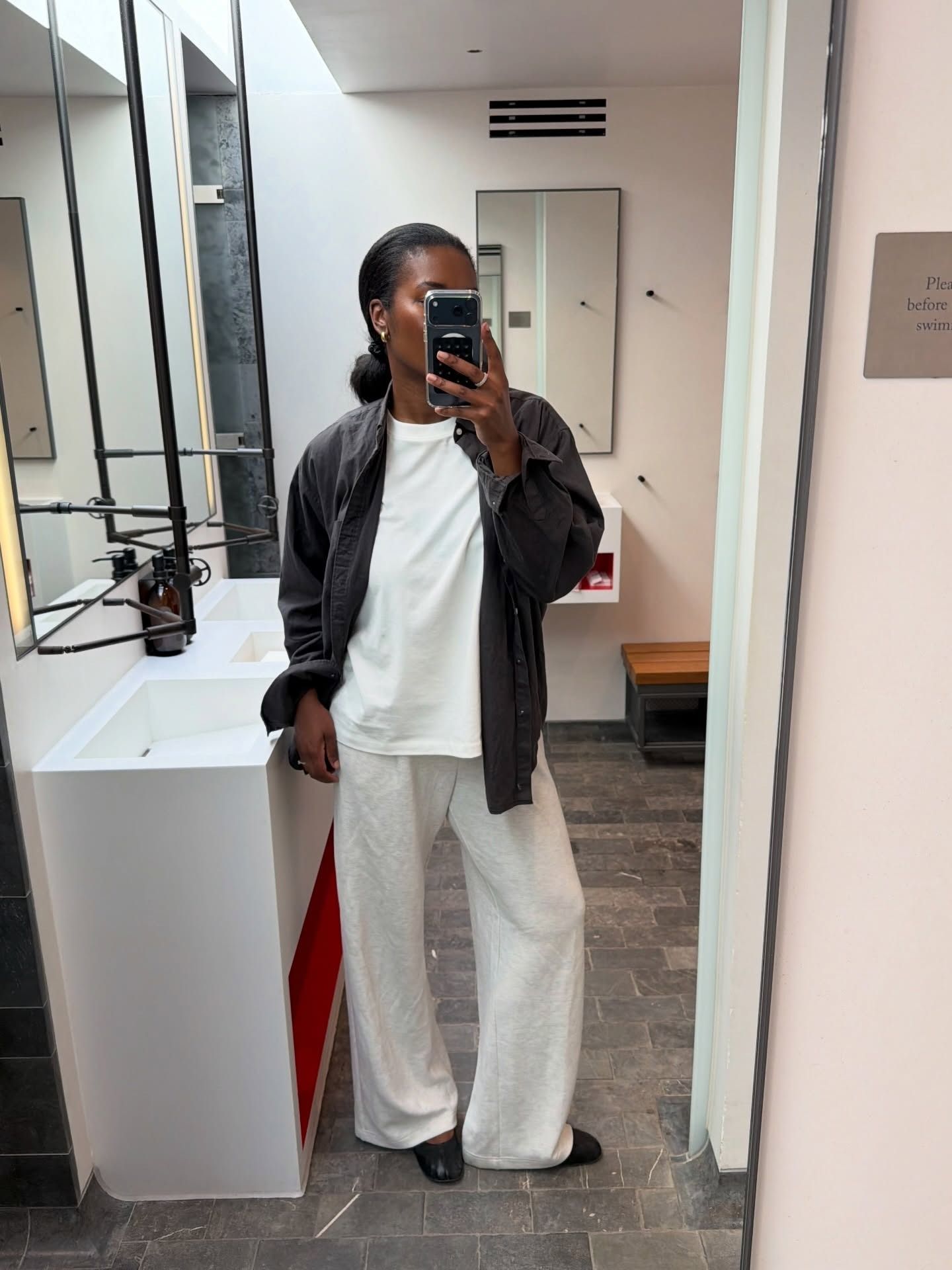 Marilyn wears a white outfit with brown jacket.