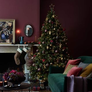 Burgundy living room with fireplace and Christmas tree