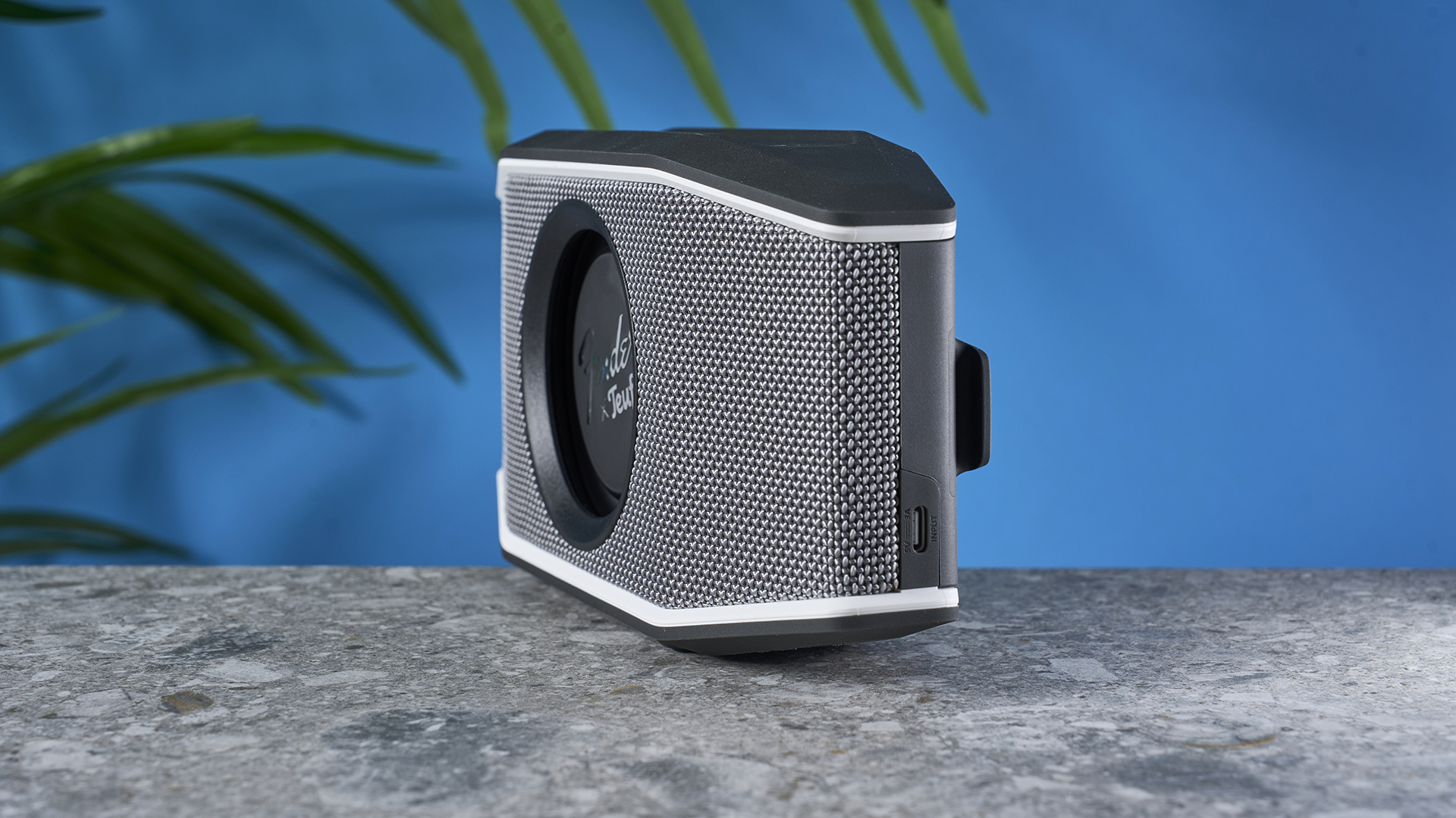 a retro-inspired bluetooth speaker 8 inches long and 4 inches tall with a circular woofer in the center branded with Fender and Teufel