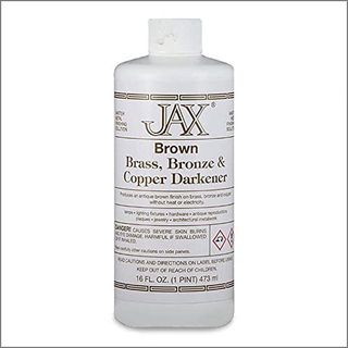 A white plastic bottle of Jax Brown Darkener with bronze accents