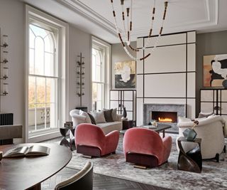 living room with white sofas and pink chairs and modern fireplace with parquet floor