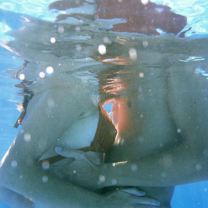 Being the other woman: A man and woman kissing in a pool