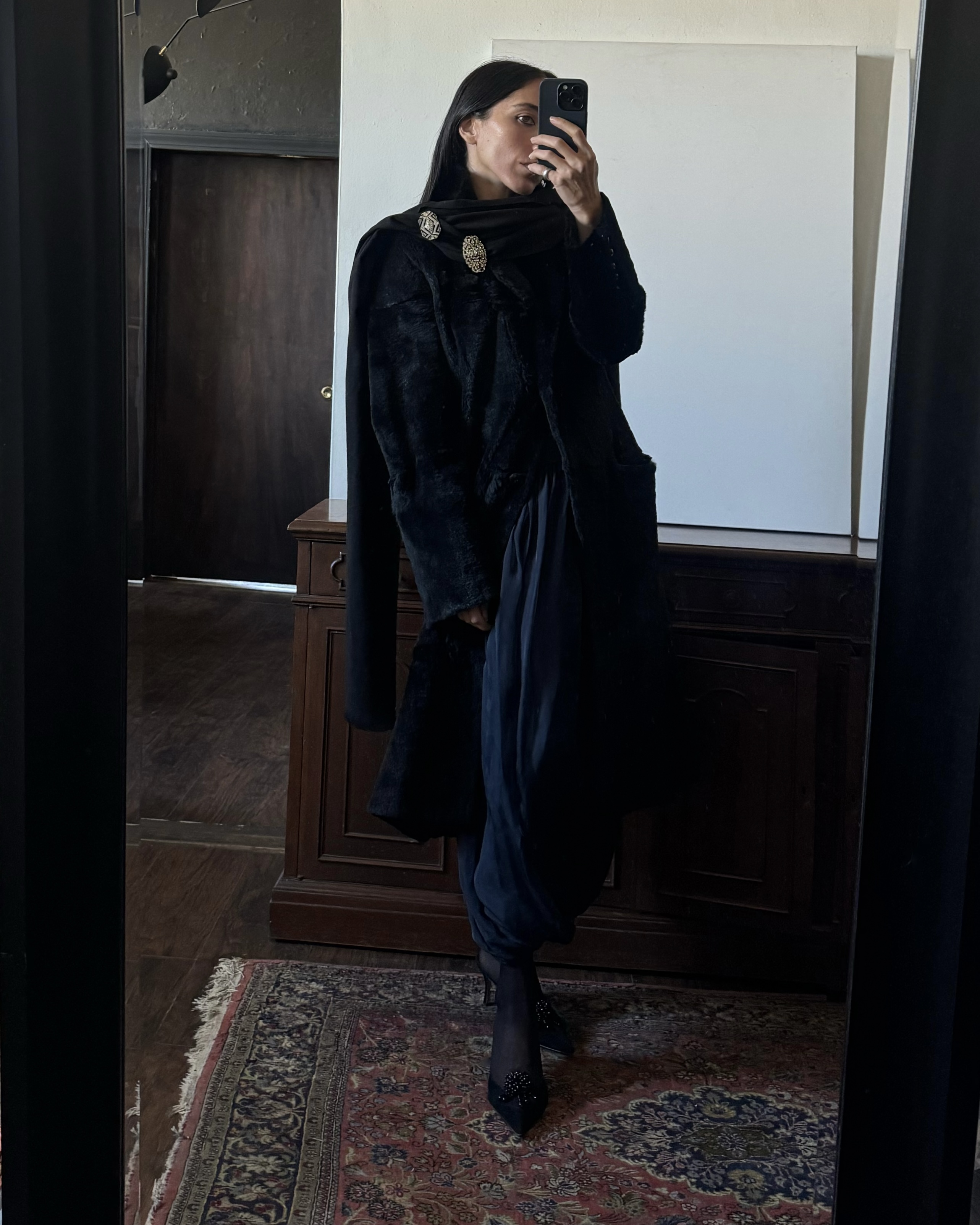 Alexis Badiyi wearing acoat and pants