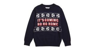best Christmas jumpers illustrated by a blue sweater featuring footballs and the slogan it's coming ho ho home