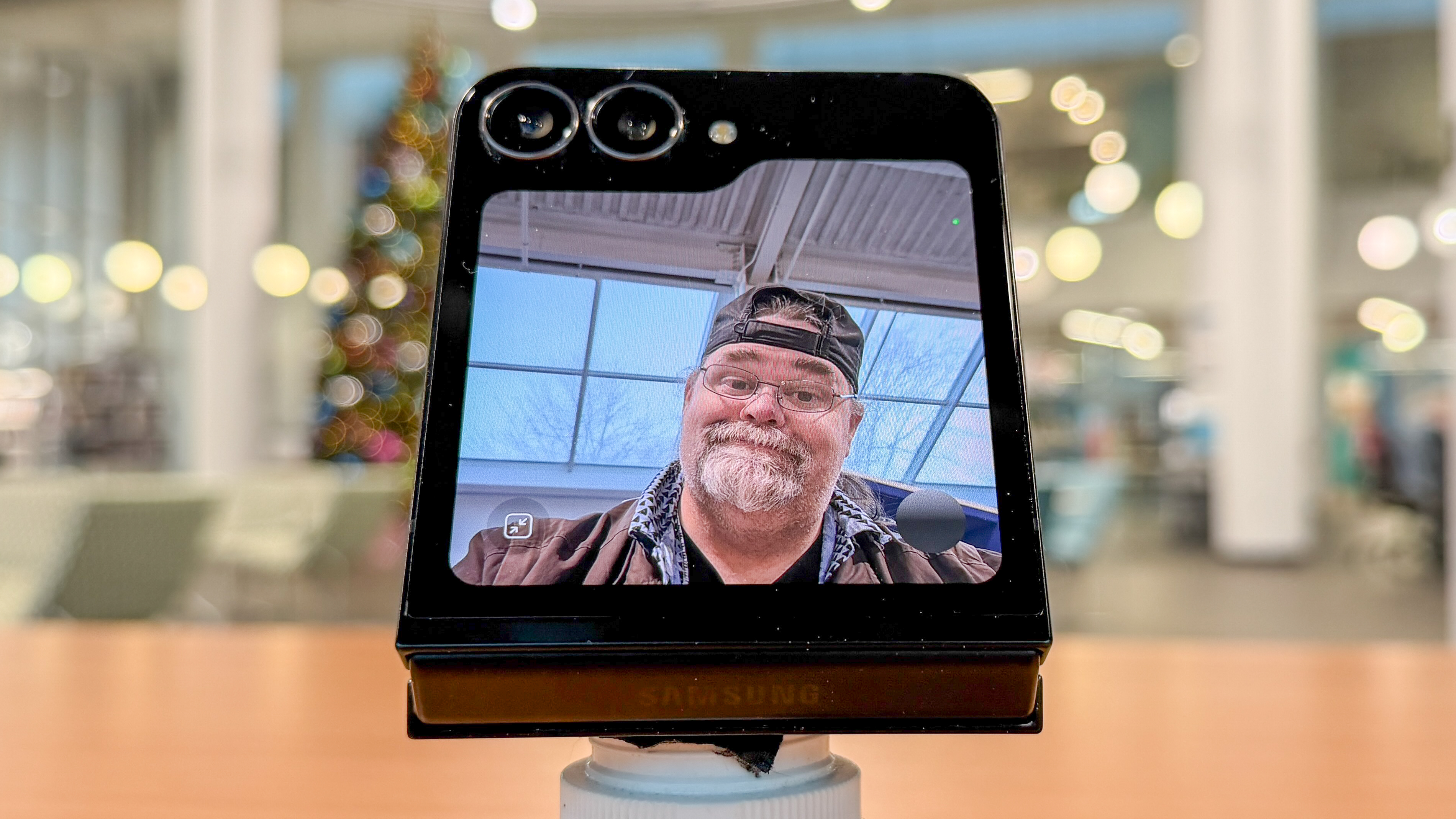 Samsung Galaxy Z Flip 7 FE in piano black color showing content on the cover display and the main screen