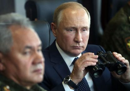 Vladimir Putin watches Russian military exercises
