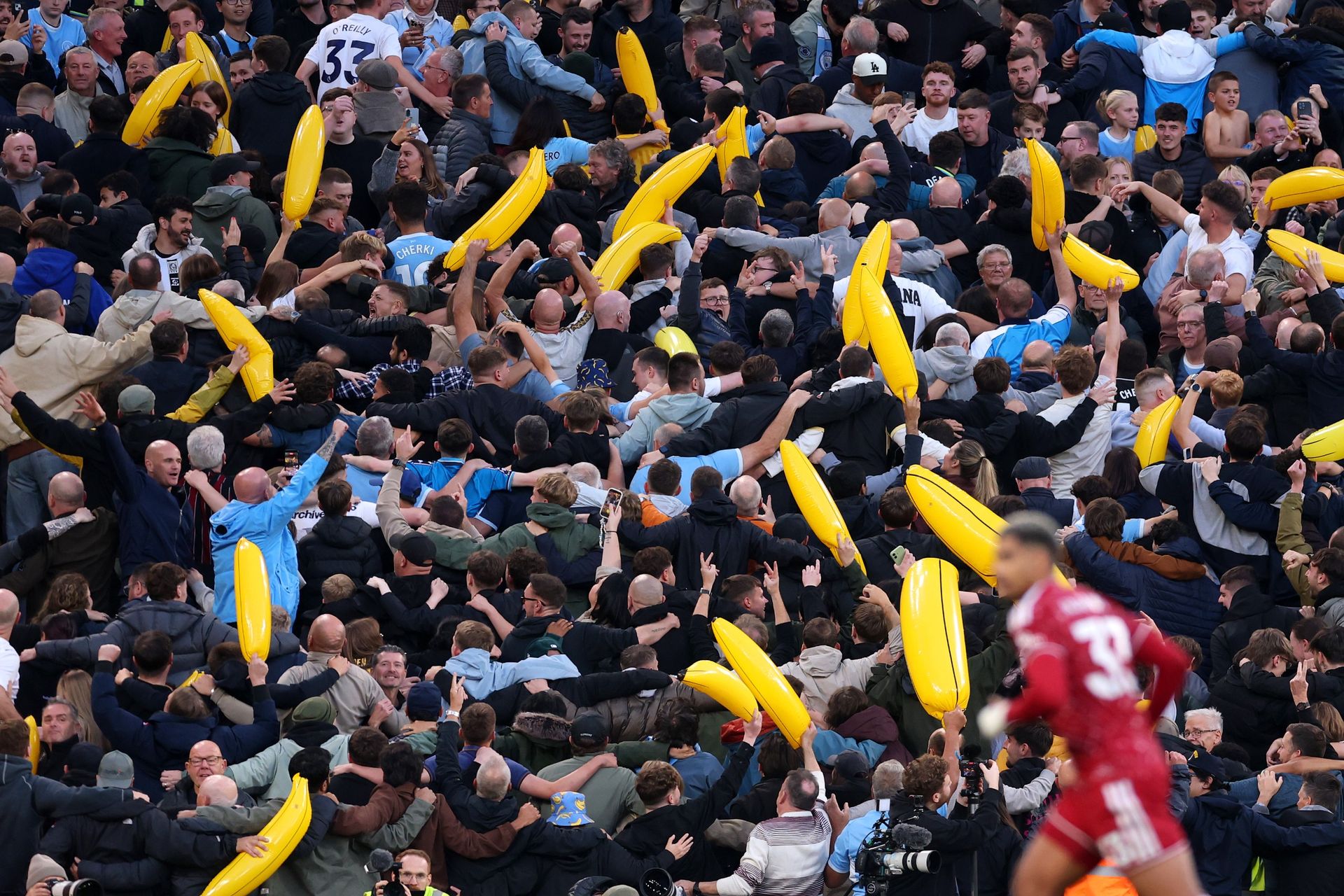 Manchester City fans celebrate their teams first goal scored by Erling Haaland