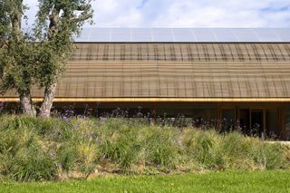 Bodegas Faustino Winery seeing its rounded roof and ceiling, The design reinterprets the winery as a whole andcreates a stronger connection between theexisting cellars and the surrounding vineyard