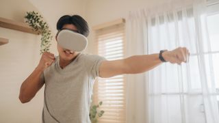 A man practicing boxing with a VR headset on.