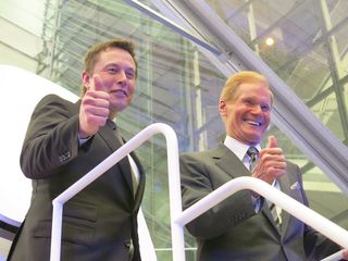 Elon Musk (left) and senator Bill Nelson (D., Fla.) stand atop the stairs before entering the manned Dragon capsule on June 10, 2014.