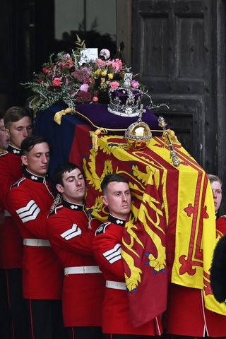 The coffin of Queen Elizabeth II with the Imperial State Crown resting on top is carried by the Bearer Party as it departs Westminster Abbey during the State Funeral of Queen Elizabeth II on September 19, 2022 in London, England. Elizabeth Alexandra Mary Windsor was born in Bruton Street, Mayfair, London on 21 April 1926.