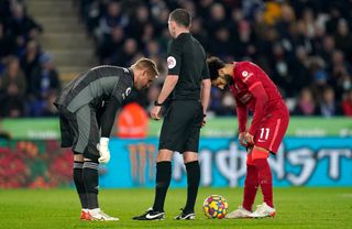 Kasper Schmeichel, left. speaks to Mohamed Salah before saving the Liverpool forward's penalty